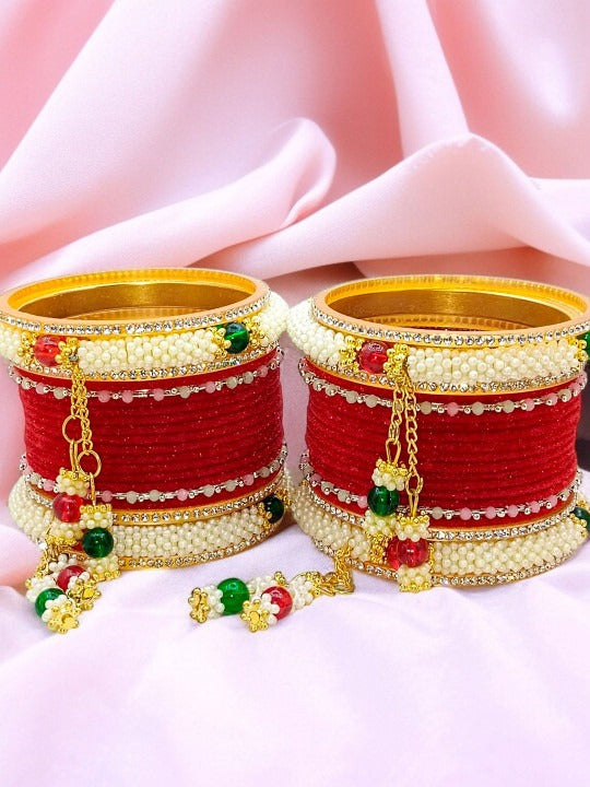 detailed view of textured red bangles with clear stone accents