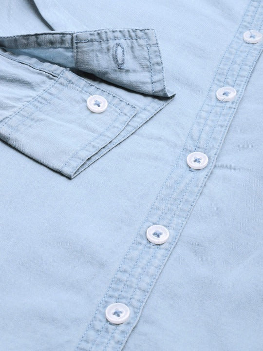Fabric drape detail of cyan blue cotton shirt