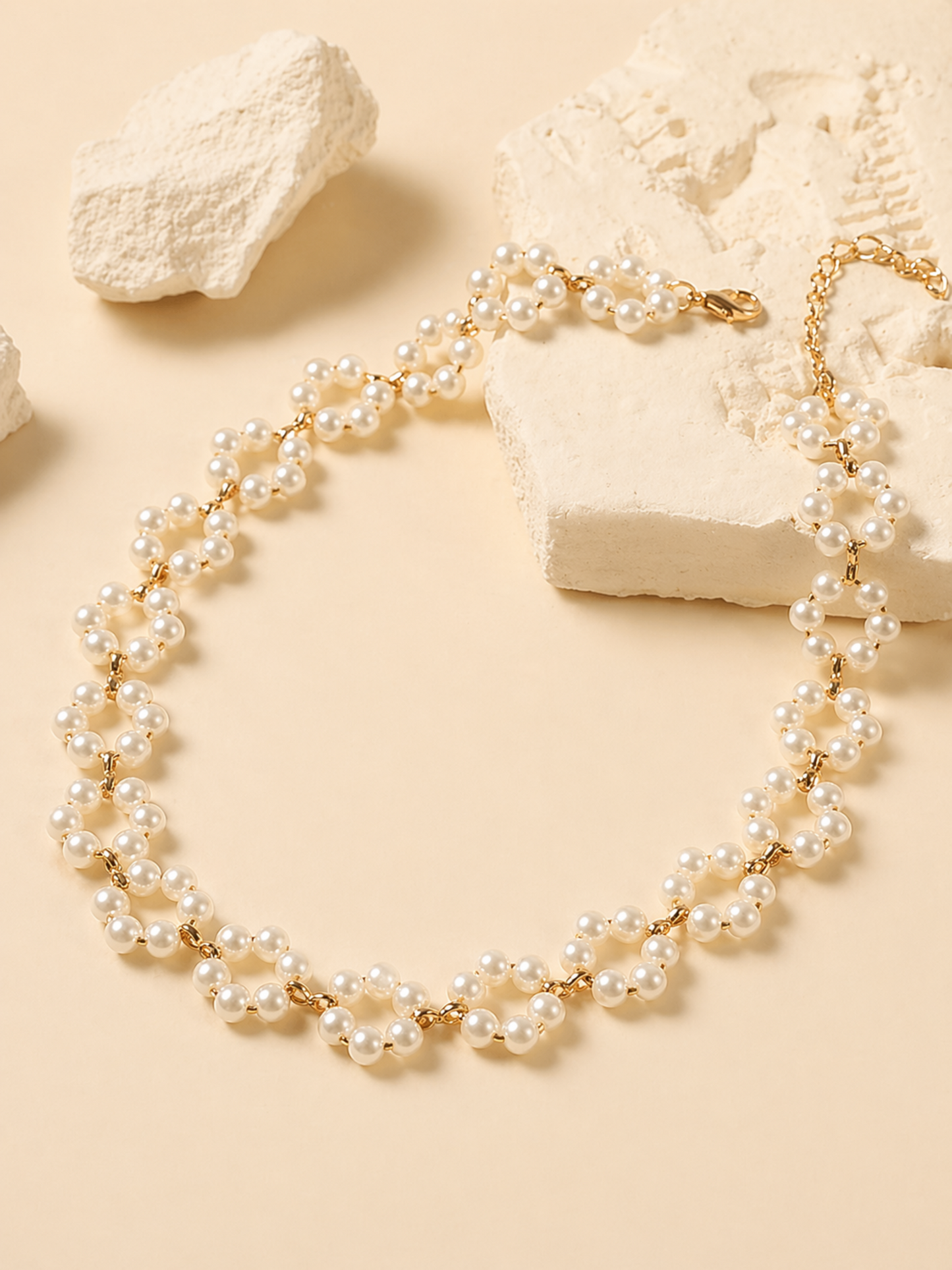 gold and pearl necklace flat lay styling