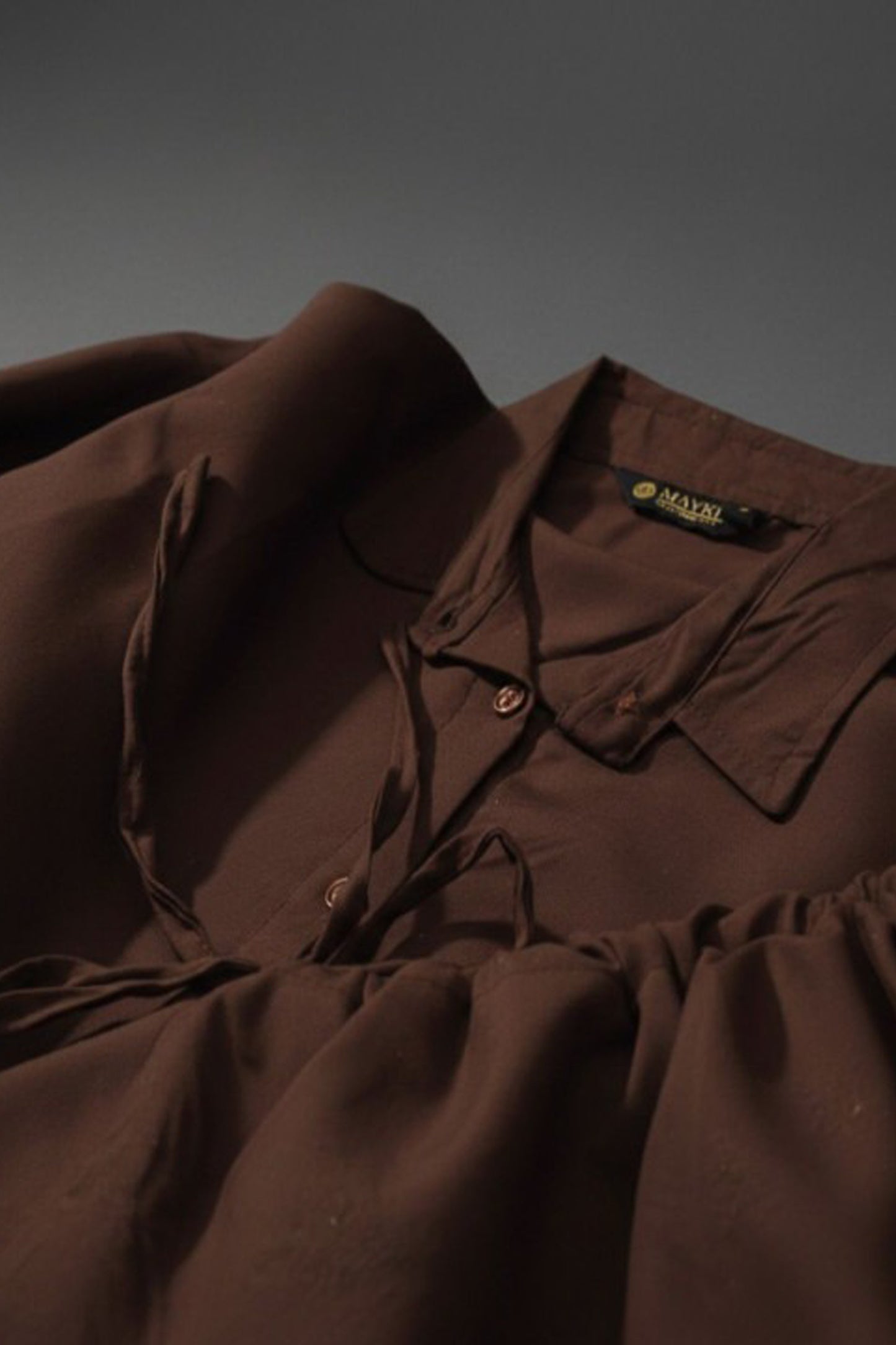 Brown cotton shirt showing the collar and sleeve detail