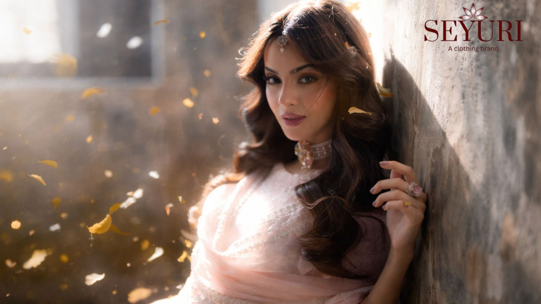 Woman wearing a pastel pink Pakistani dress for Eid, standing in soft natural sunlight