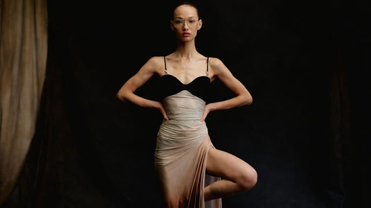 Elegant minimalist dress outfit on model with dark background, luxury fashion look 2026