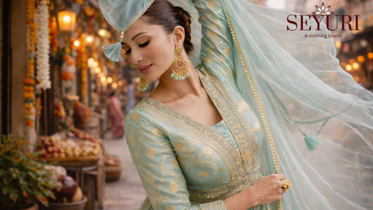Mint green embroidered Anarkali dress with gold detailing and flowing dupatta on modern street background.
