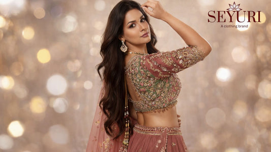 Side-pose bridal lehenga in blush pink and sage green with intricate floral embroidery, styled on a model against a soft neutral background