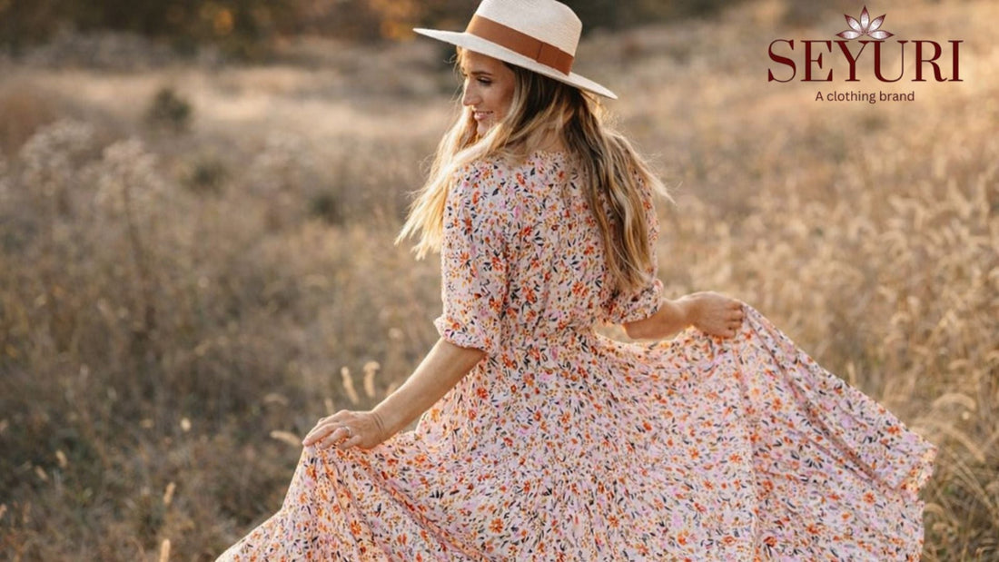Woman wearing a flowy floral maxi dress in a field, showcasing spring 2026 fashion trends with soft pastel colors and feminine silhouette