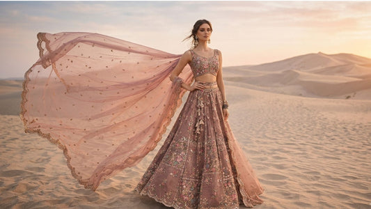 dusty rose lehenga for wedding guest in desert photoshoot with floral embroidery and flowing dupatta