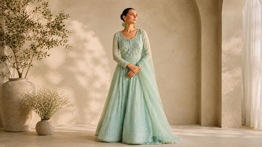 Soft luxury Anarkali gown in mint green with elegant embroidery and minimalist editorial fashion styling.