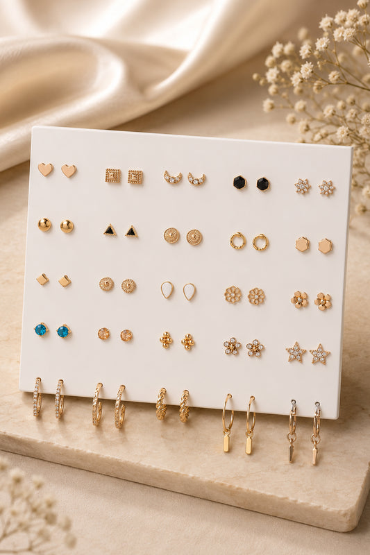 30 pairs gold earrings set displayed on an ivory board