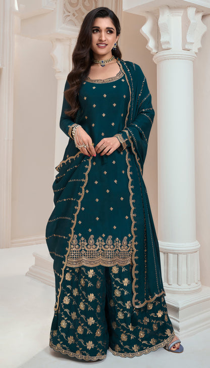 A Woman Wearing a Traditional Teal Palazzo Dress with Dupatta Featuring Embroidered