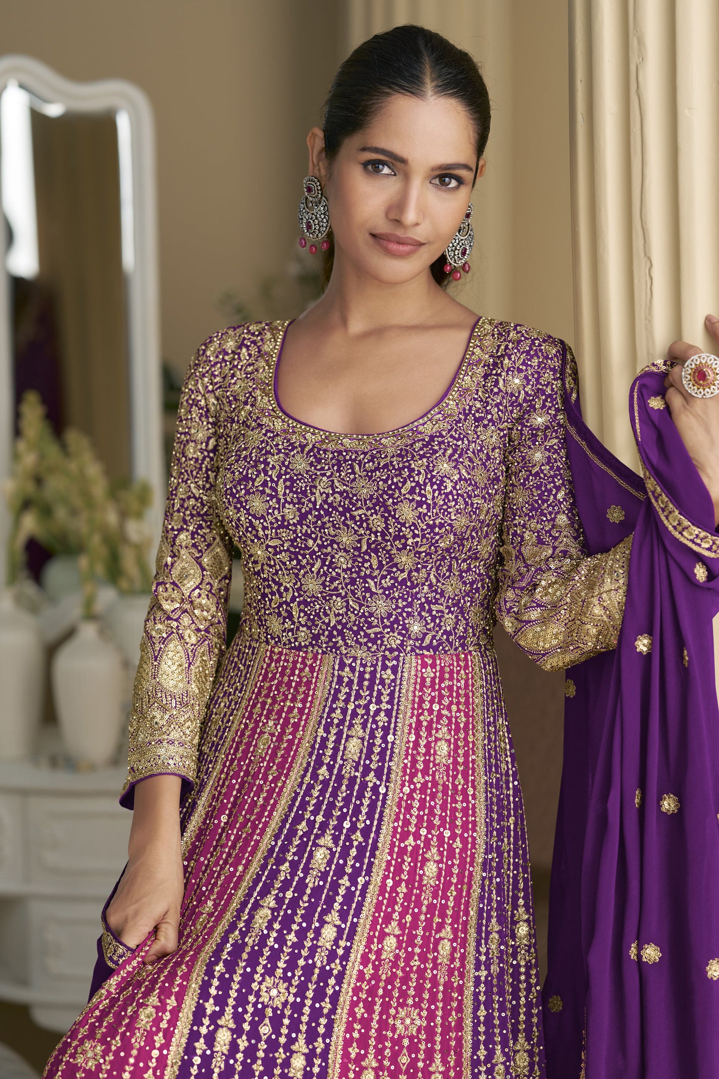 Woman wearing a traditional outfit with a purple dupatta 