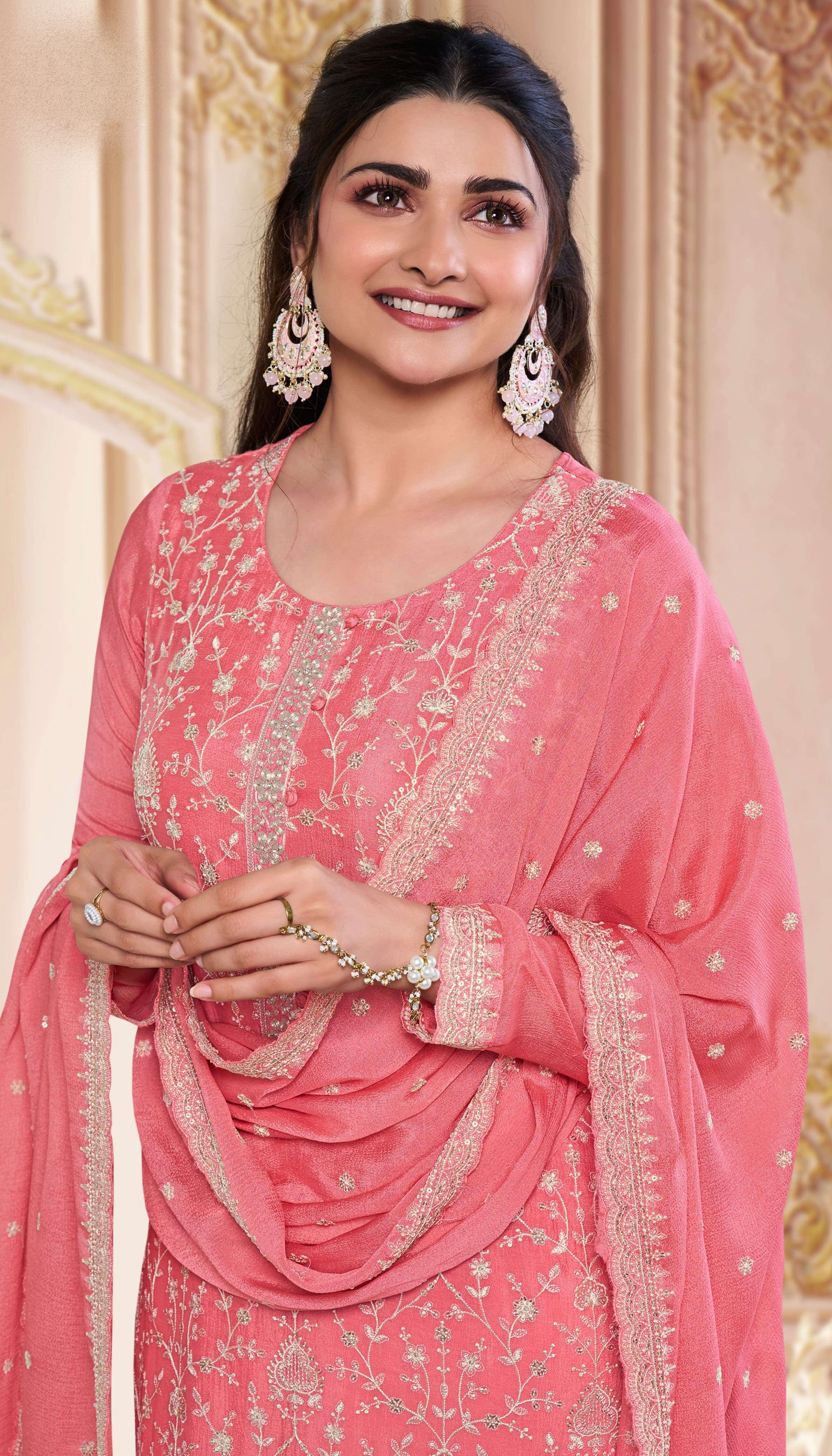 Close-up of embroidered chinon fabric on peach kameez