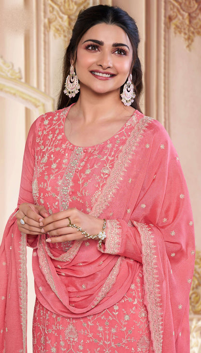 Close-up of embroidered chinon fabric on peach kameez