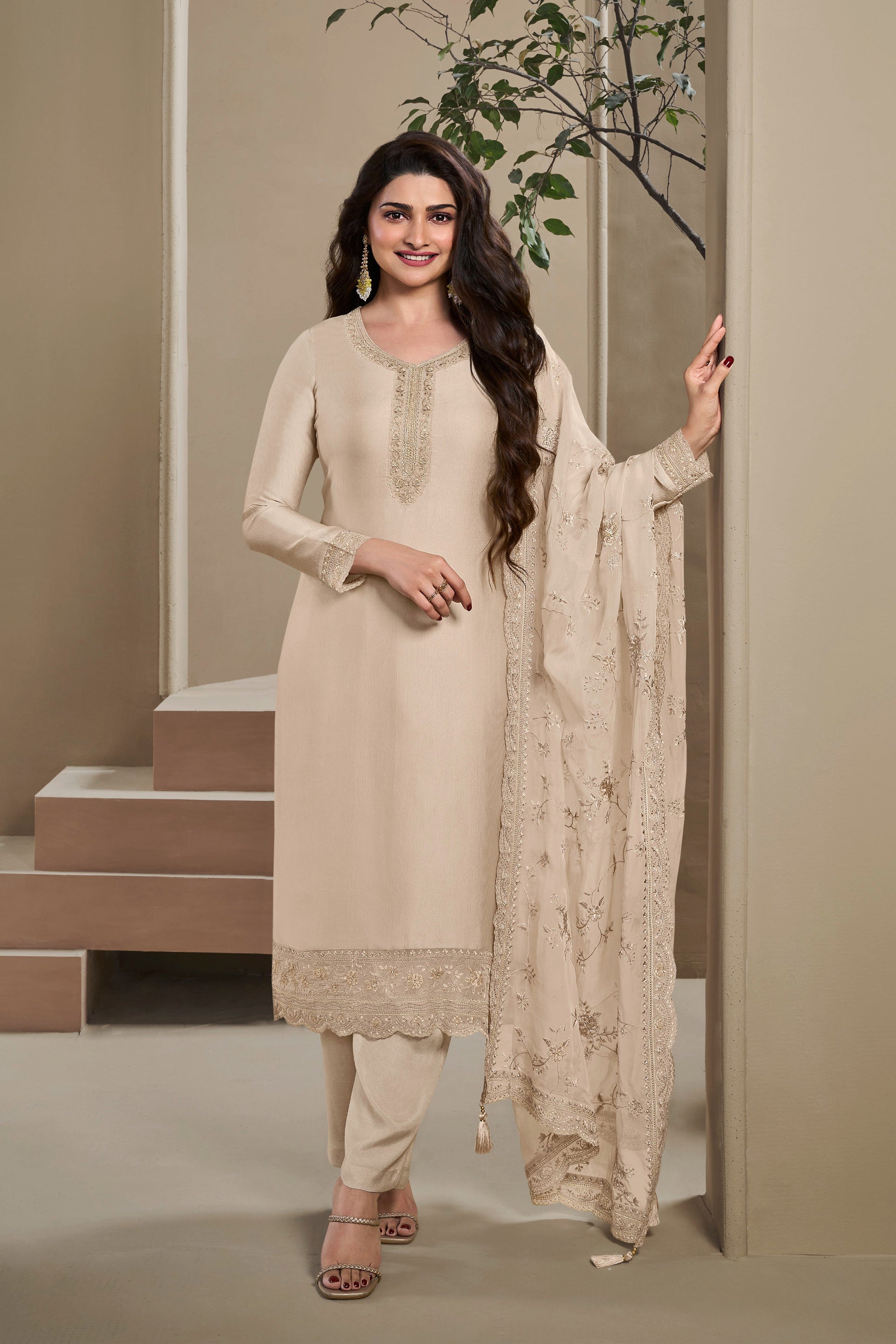 Woman in a beige traditional outfit standing american House