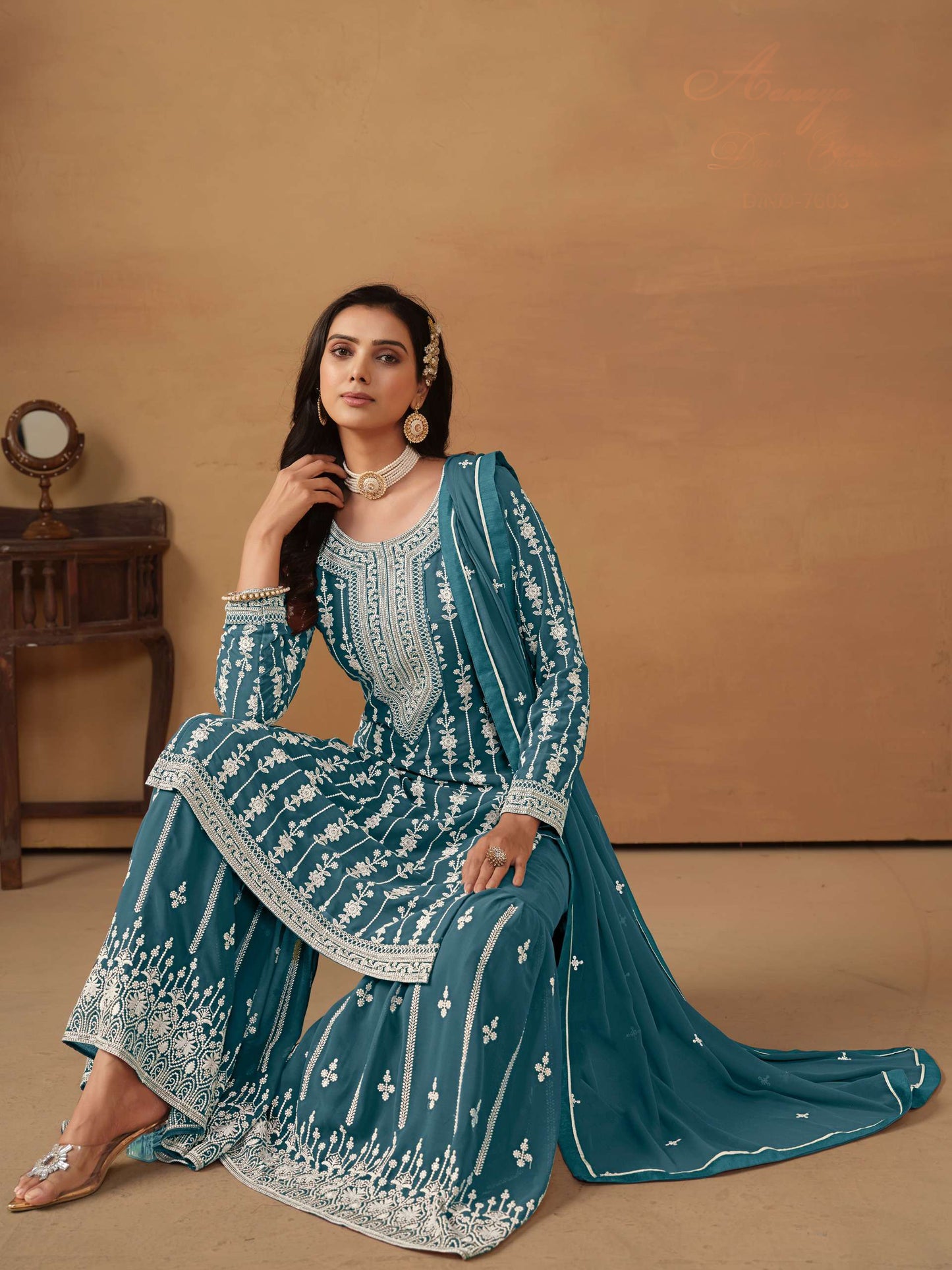 Teal sharara suit showcasing detailed embroidery