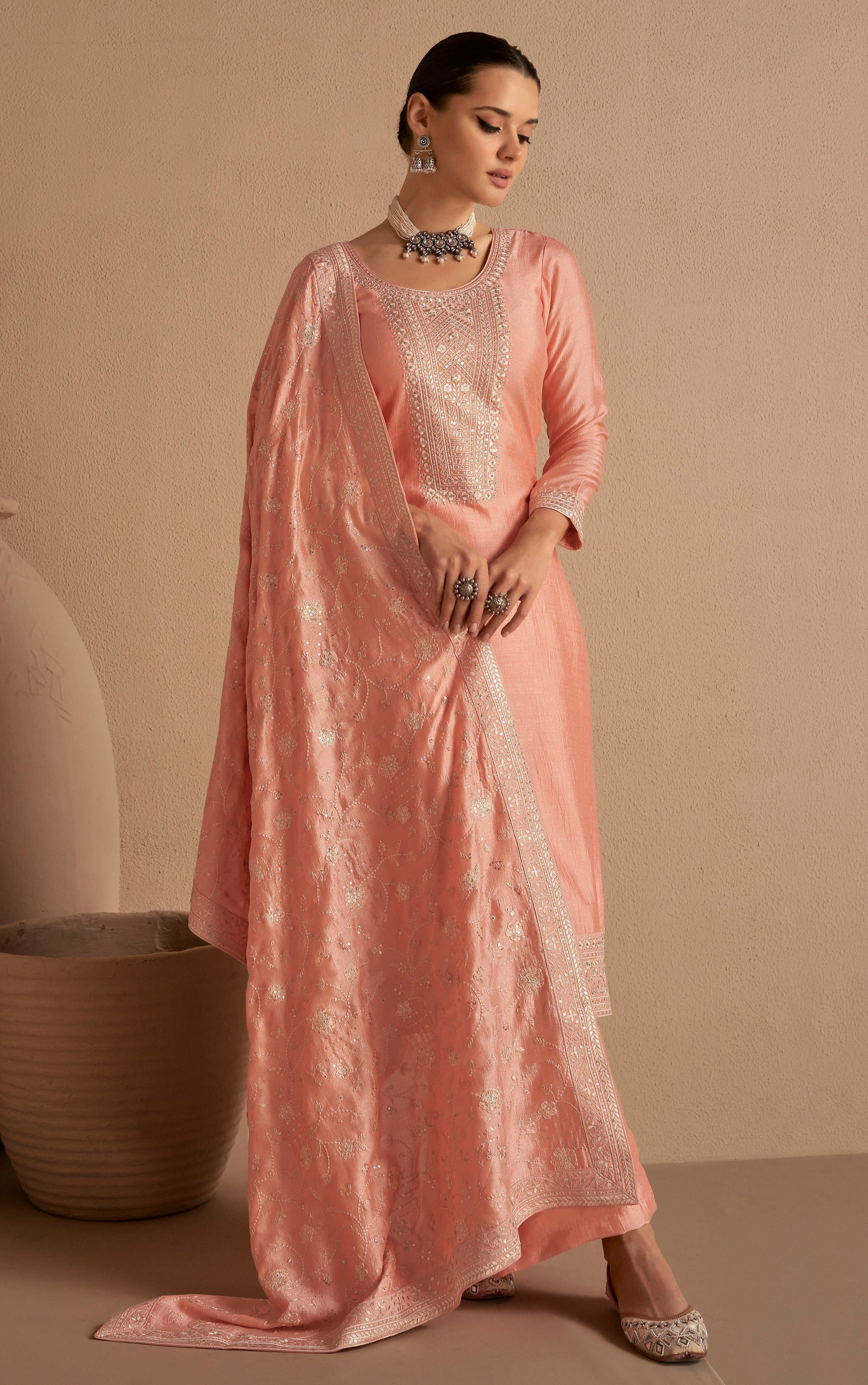 Full-length peach kameez shalwar styled for wedding reception