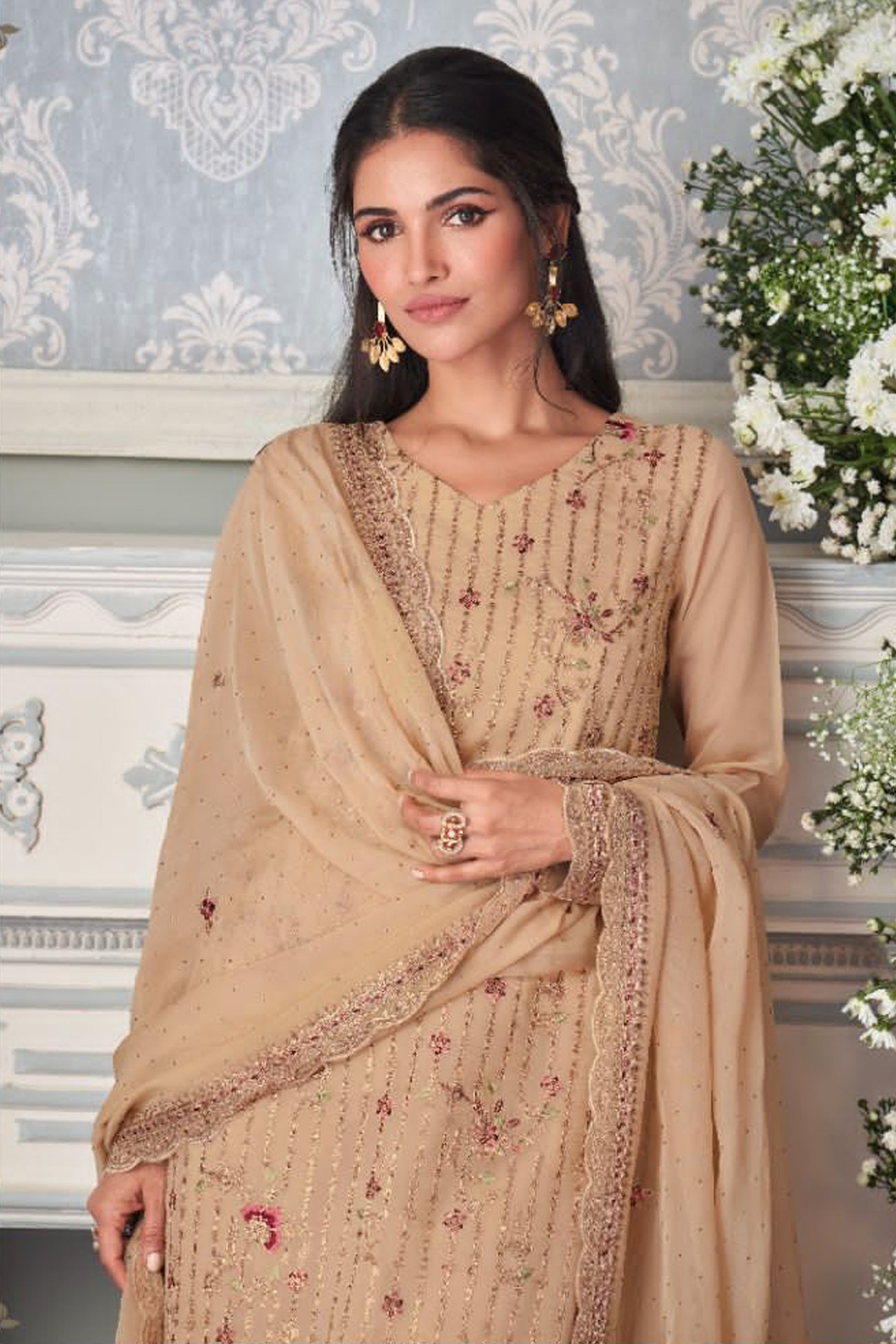 detailed embroidery work on brown Indian suit