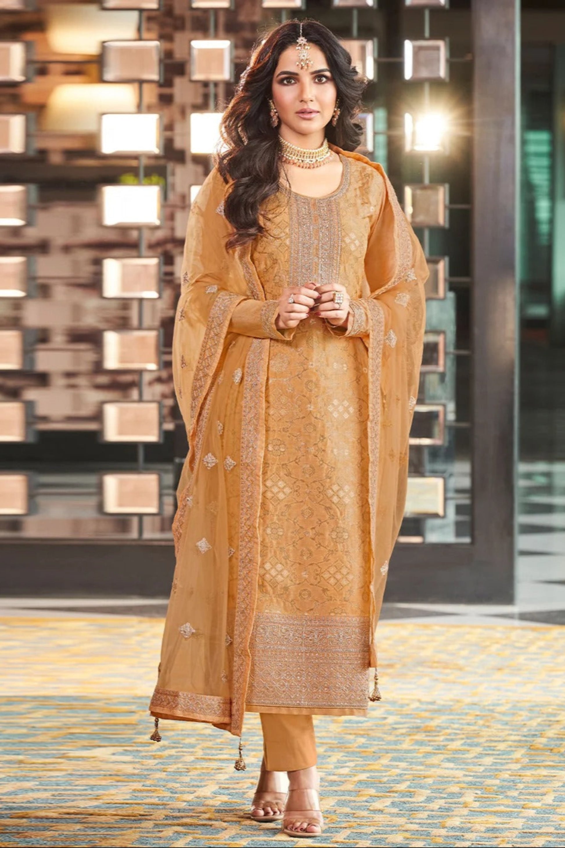 Woman Wearing a Mustard-Gold Embroidered Salwar Kameez With Intricate Thread Work.
