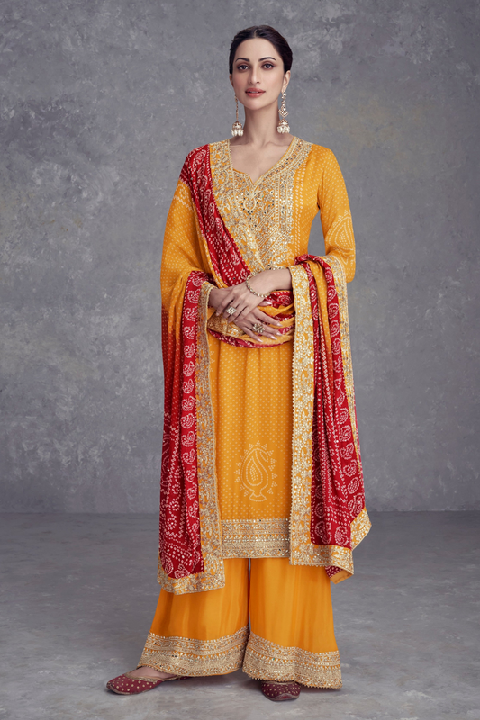 The yellow designer wedding palazzo suit is styled with a long embroidered and elegant palazzo pants for a festive wedding look.
