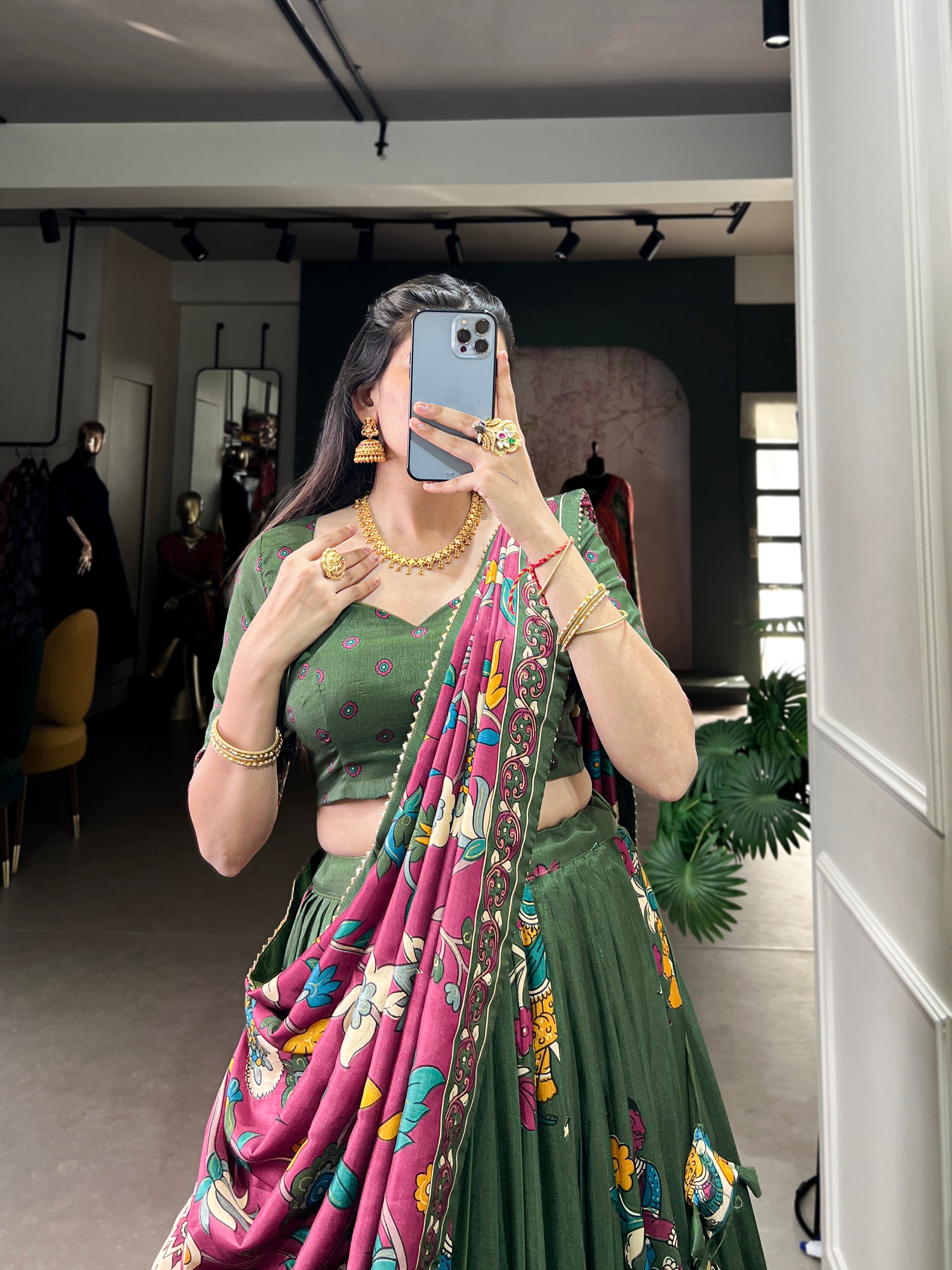 Dark green Tussar silk lehenga with Kalamkari print work, showcasing timeless traditional charm with a rich festive appeal.
