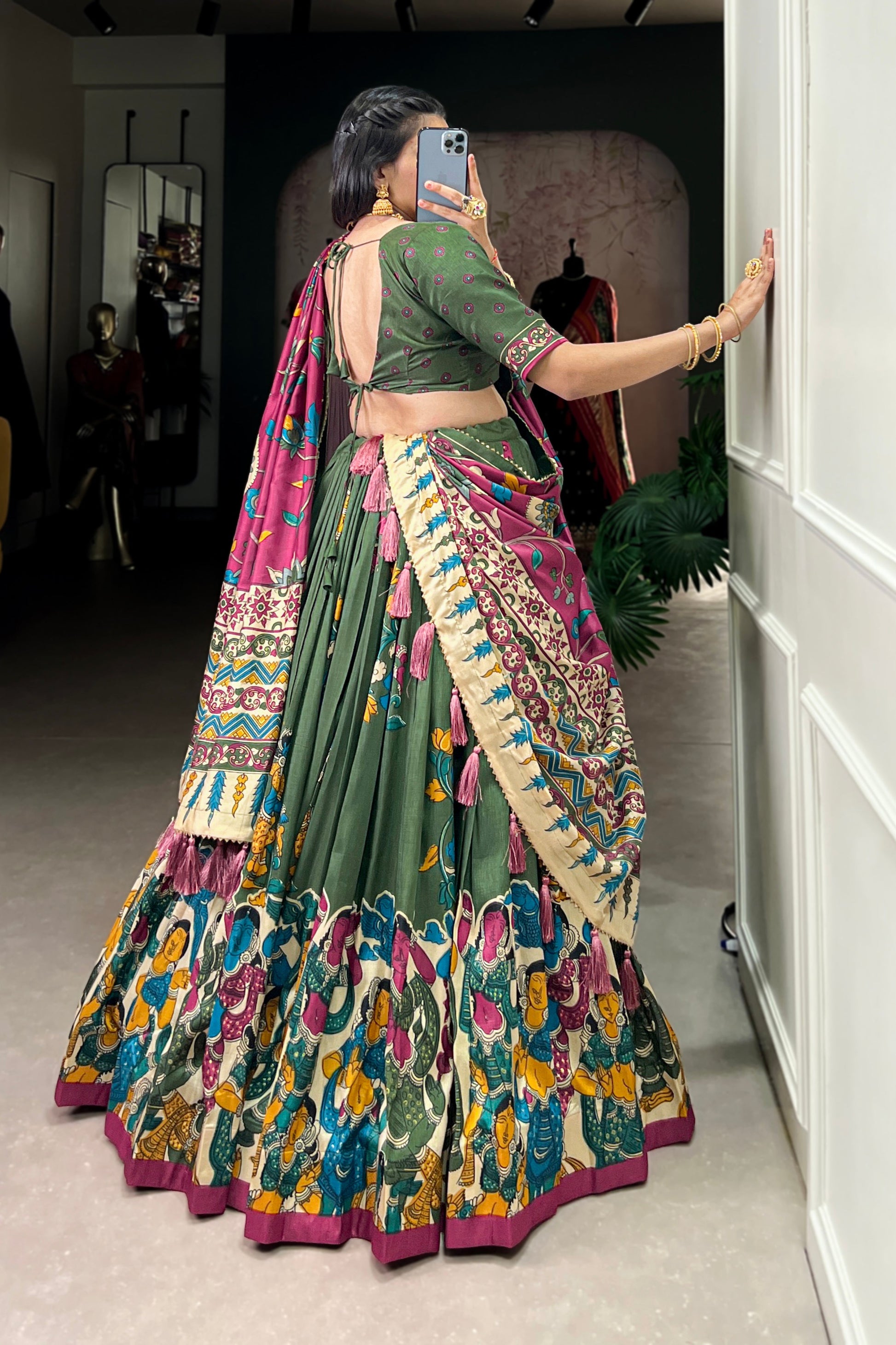 Dark green Tussar silk lehenga with Kalamkari print work, showcasing timeless traditional charm with a rich festive appeal.
