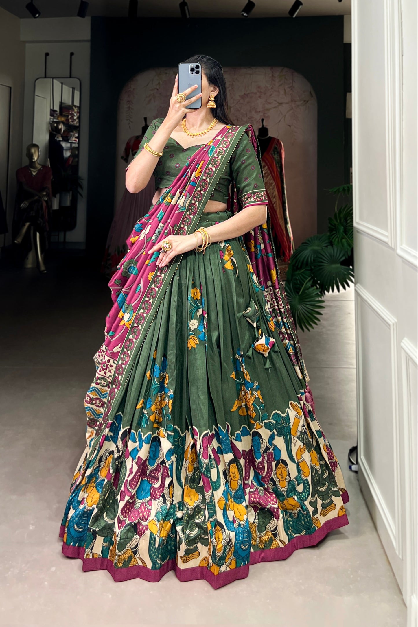 Dark green Tussar silk lehenga with Kalamkari print work, showcasing timeless traditional charm with a rich festive appeal.
