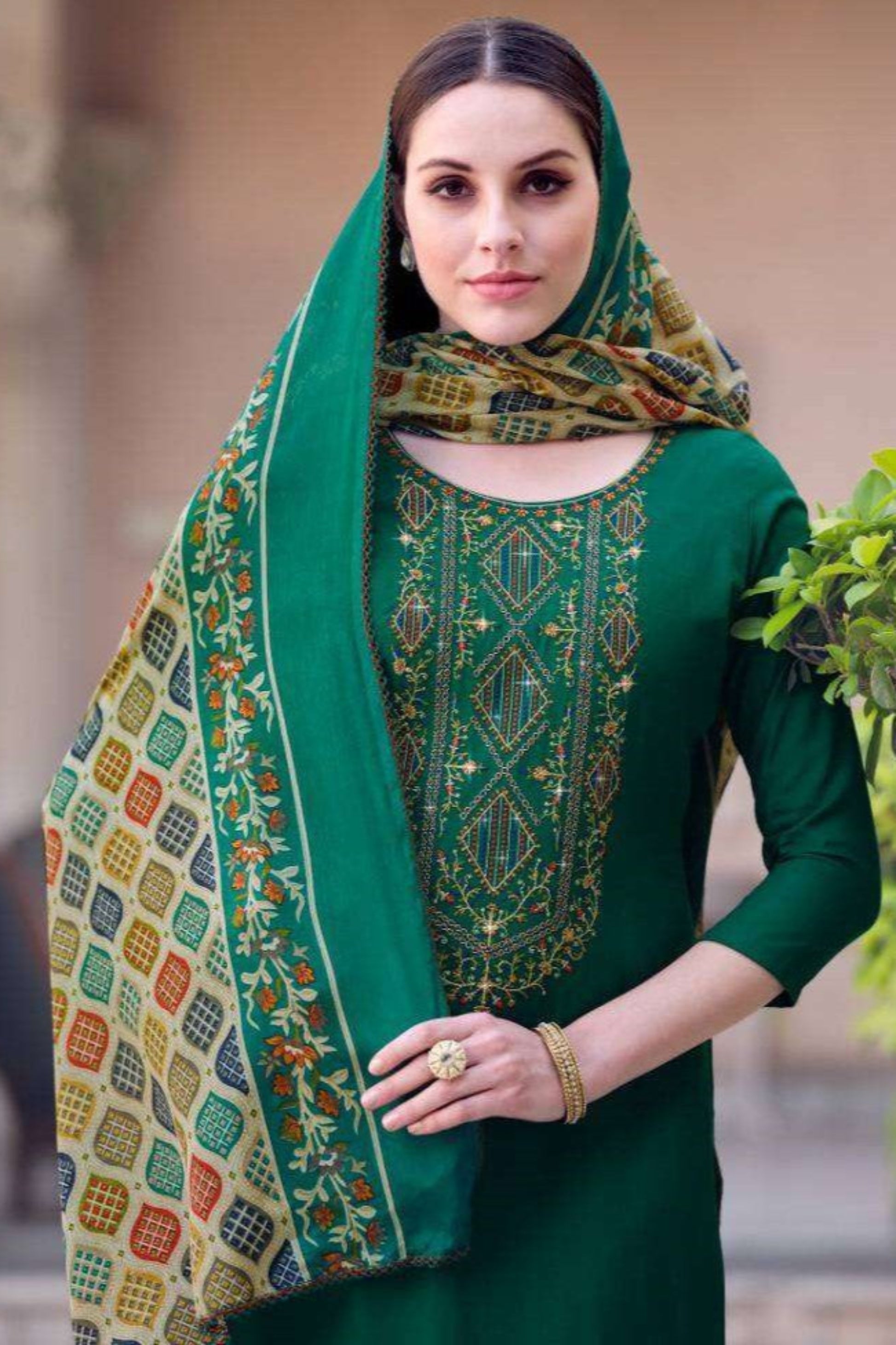 Dark green salwar kameez set with dupatta, ideal for festive wear