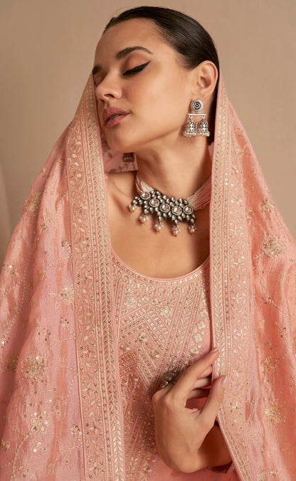 Close-up of embroidery work on peach silk salwar kameez