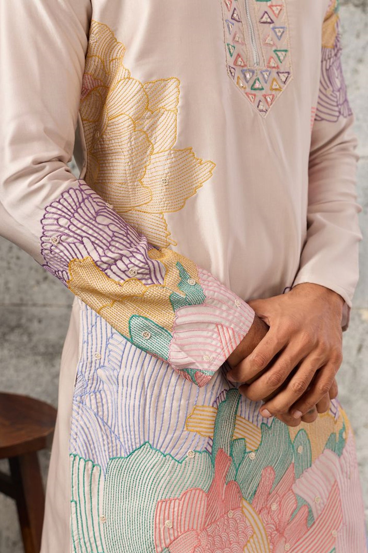 Sleeve detail of the peach embroidered men's kurta.