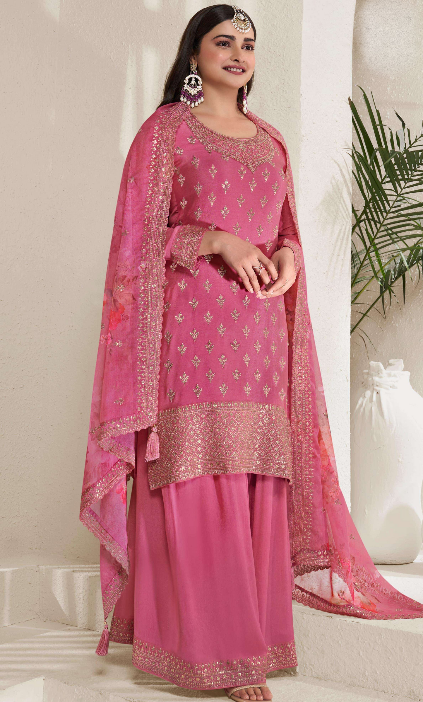 A Woman Wearing a Pink Salwar Kameez Palazzo Dupatta Dress with Embroidery Work.