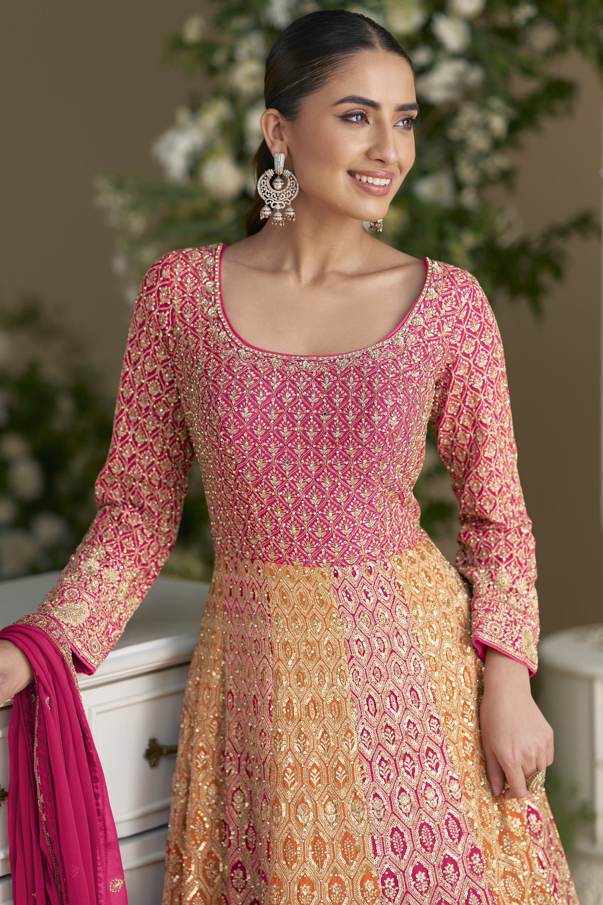 Woman Wearing a Traditional Outfit With Pink and Orange Patterns, With a Pink Dupatta