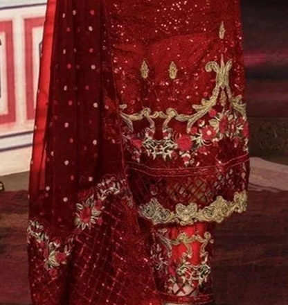 A close-up of a red embroidered traditional outfit with matching dupatta, featuring intricate gold and silver sequin work, floral embroidery, and metallic lace borders.