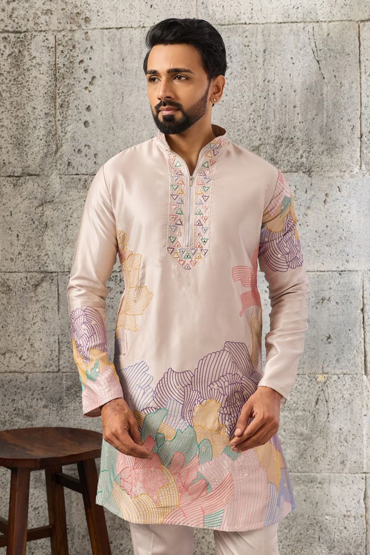 Peach kurta pajama set with embroidered detailing.