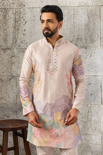 Peach kurta pajama set with embroidered detailing.