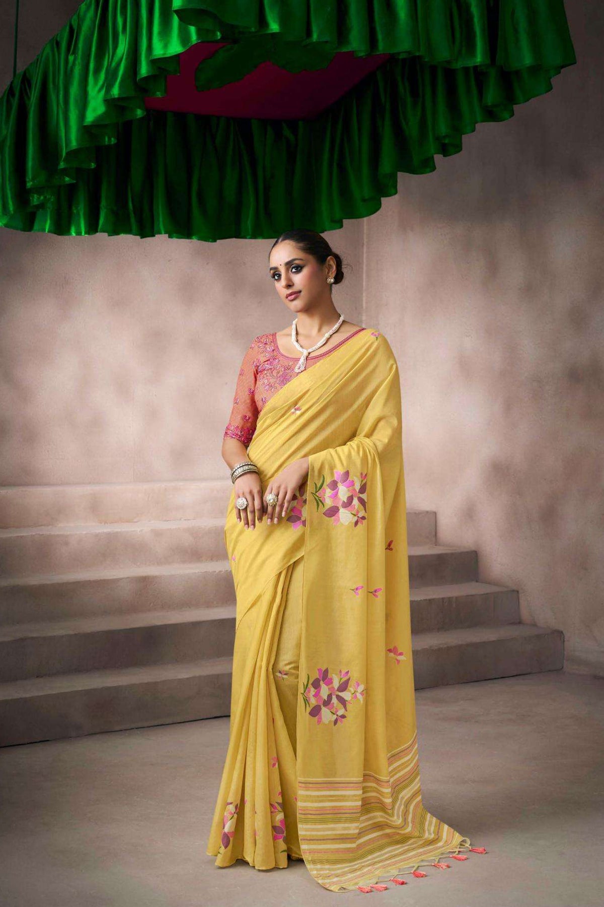 Yellow designer saree with embroidered border and stitched blouse