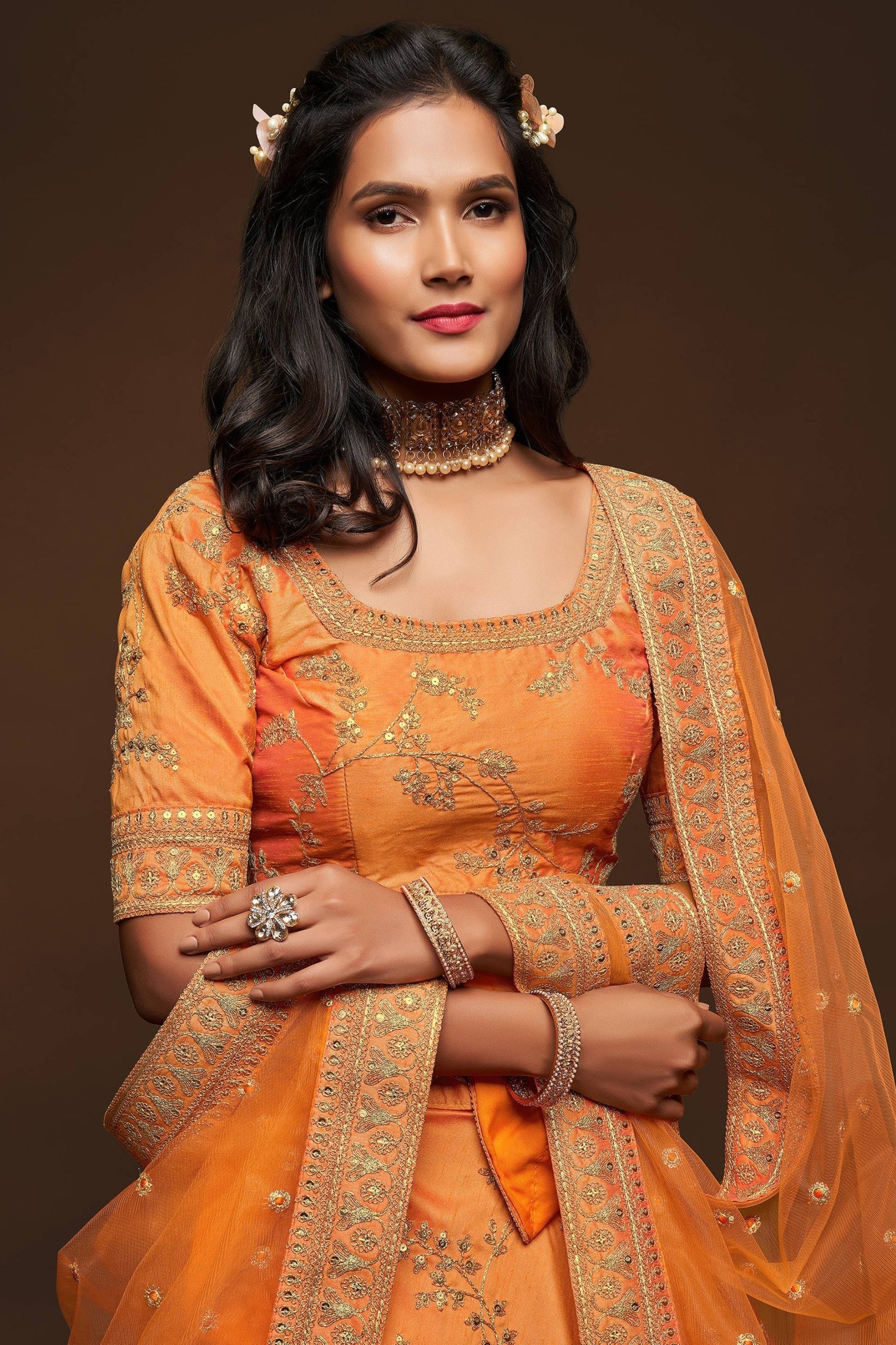 Close-up of thread embroidery on art silk bridal lehenga
