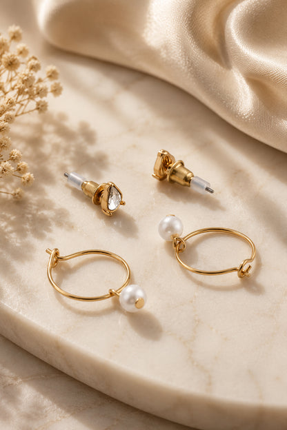 Close view of teardrop studs and pearl-drop hoop earrings