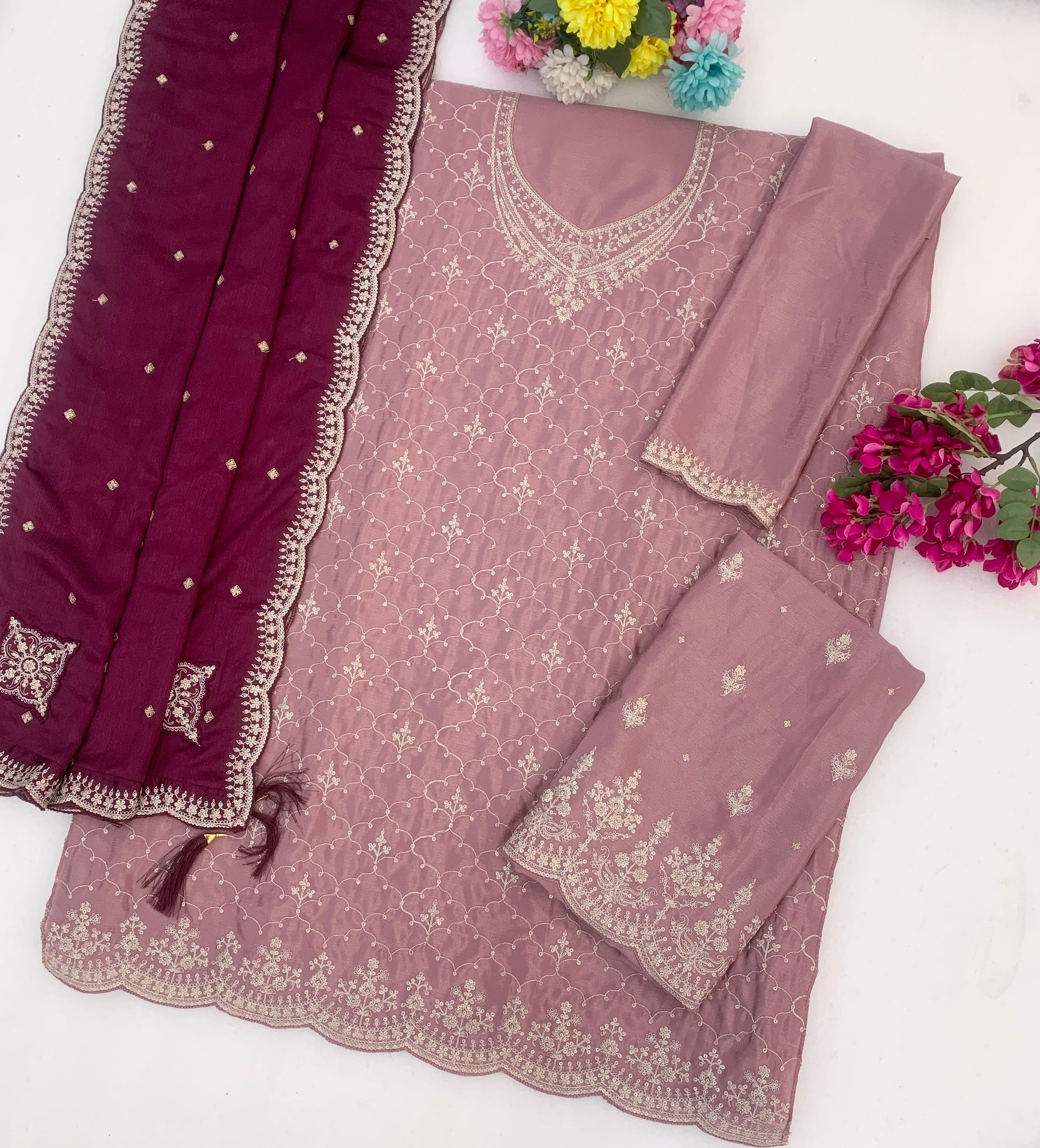 Neckline embroidery detail on baby pink outfit