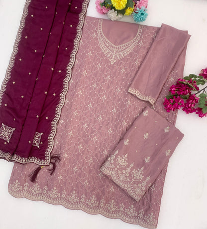Neckline embroidery detail on baby pink outfit