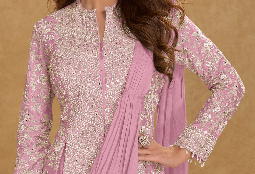 Close-up of embroidered blouse in baby pink saree