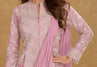 Close-up of embroidered blouse in baby pink saree
