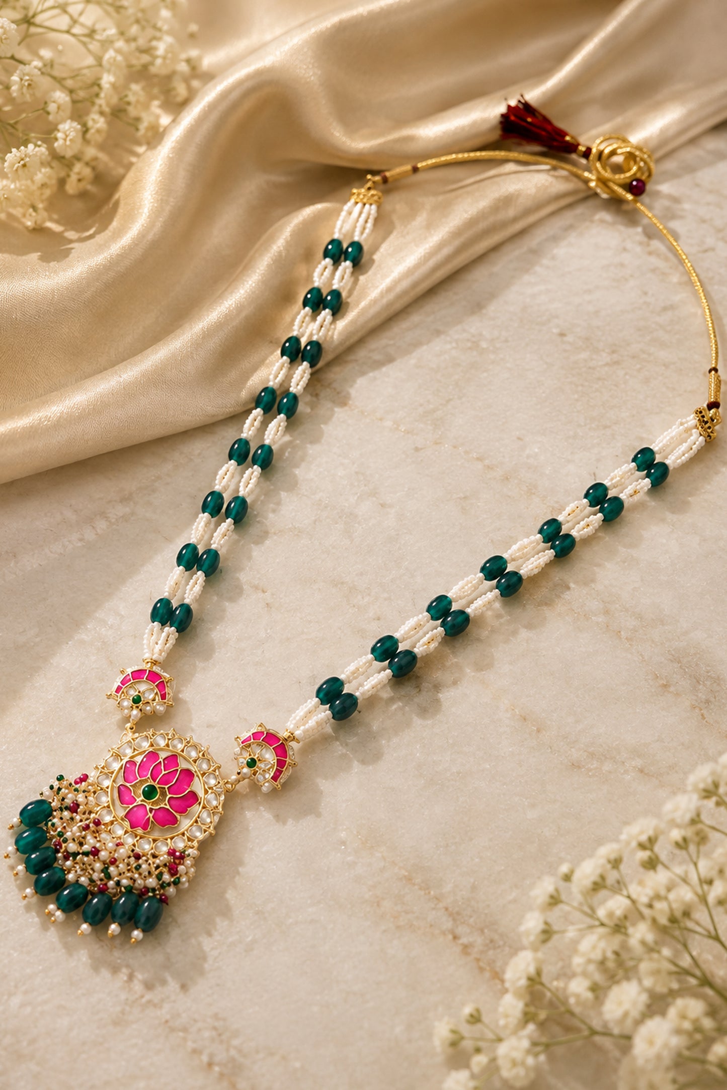 Gold-tone statement ring with sculpted pink lotus motif and green center
