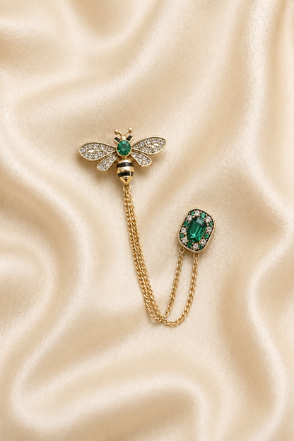 bee brooch pin with green stone and chain detail