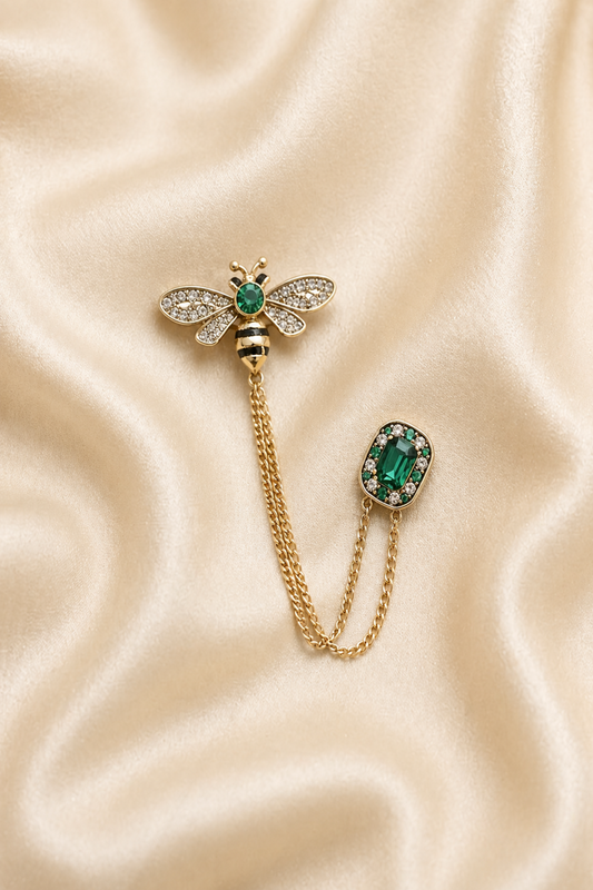 bee brooch pin with green stone and chain detail
