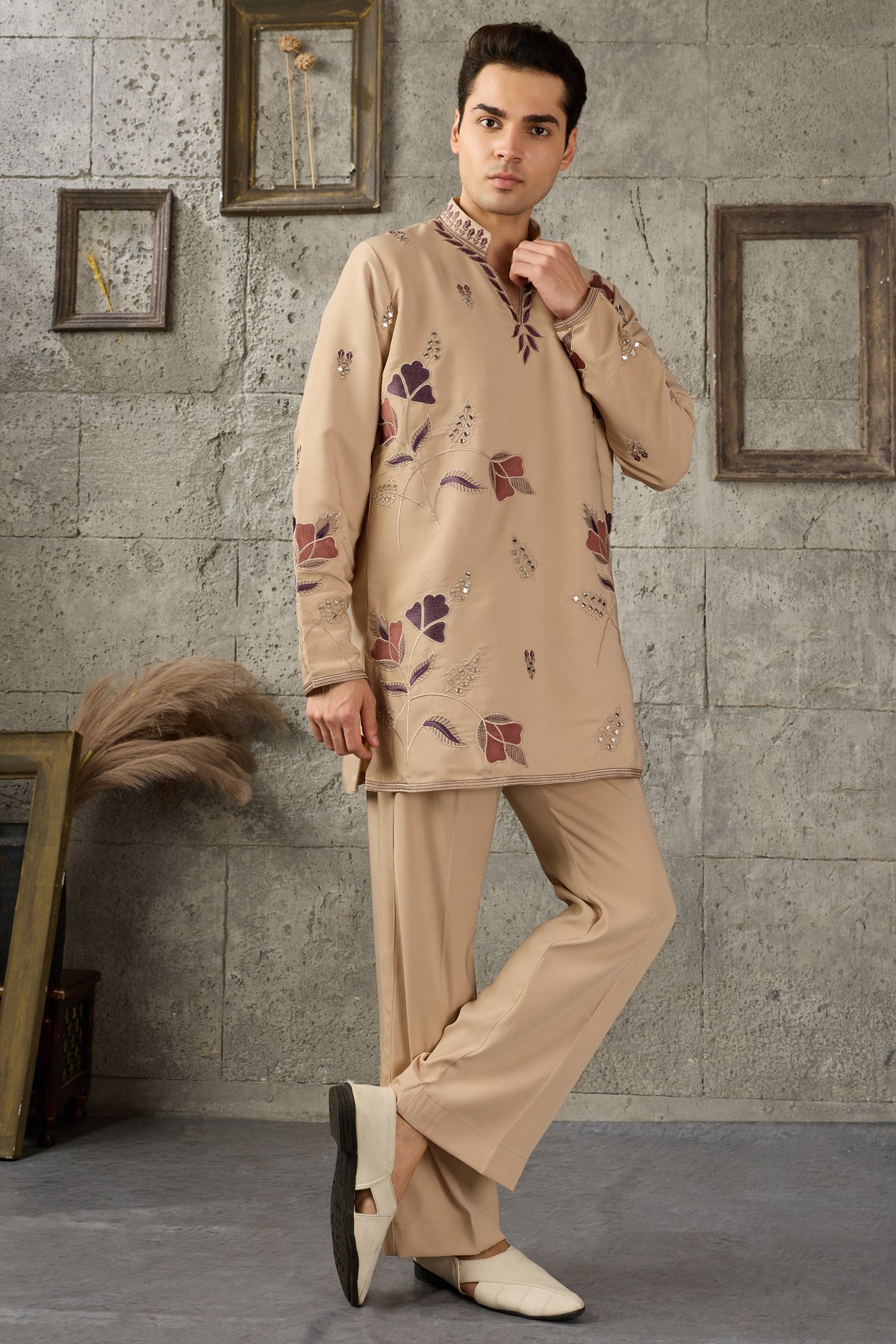 Close-up of thread embroidery on the beige kurta