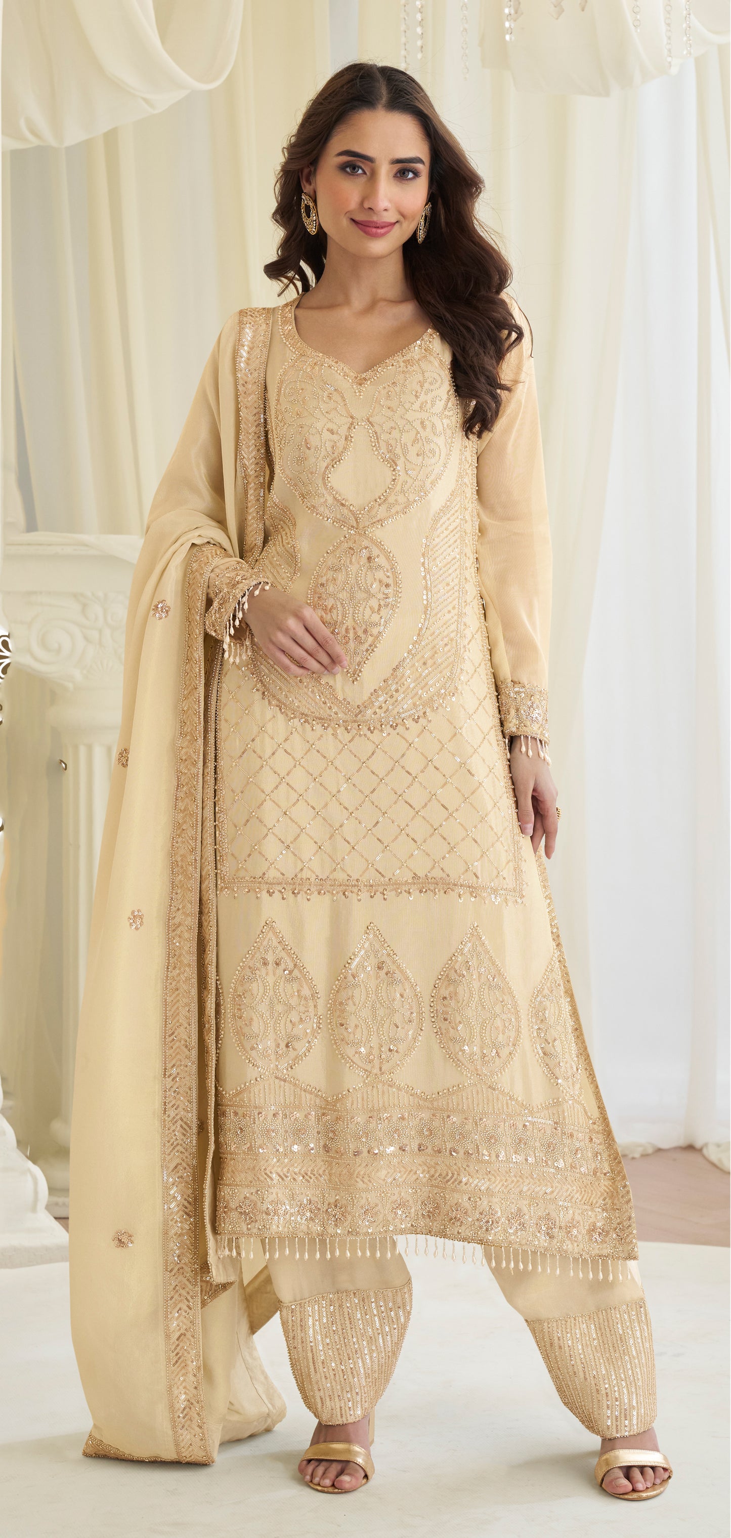 Beige ethnic sharara suit styled for wedding event