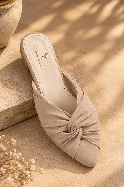 Pair of beige women’s mules with closed rounded toes