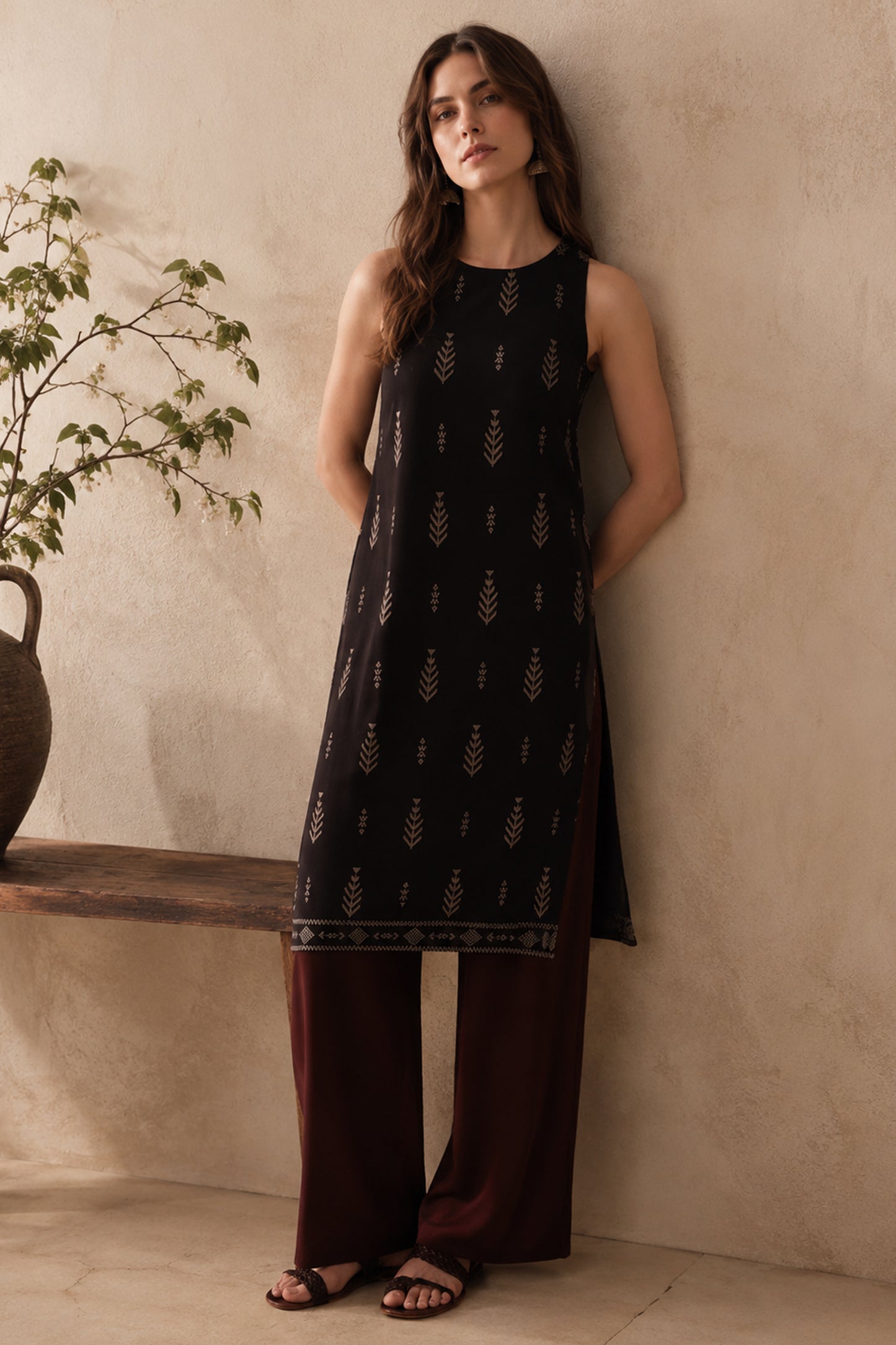 Black straight tunic paired with flowy pants indoors