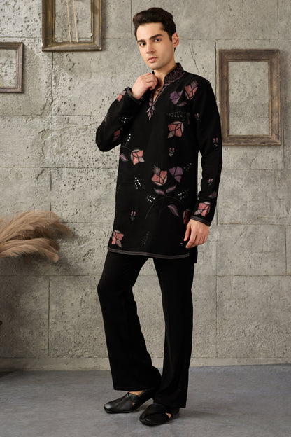 Close-up of thread embroidery on the black kurta