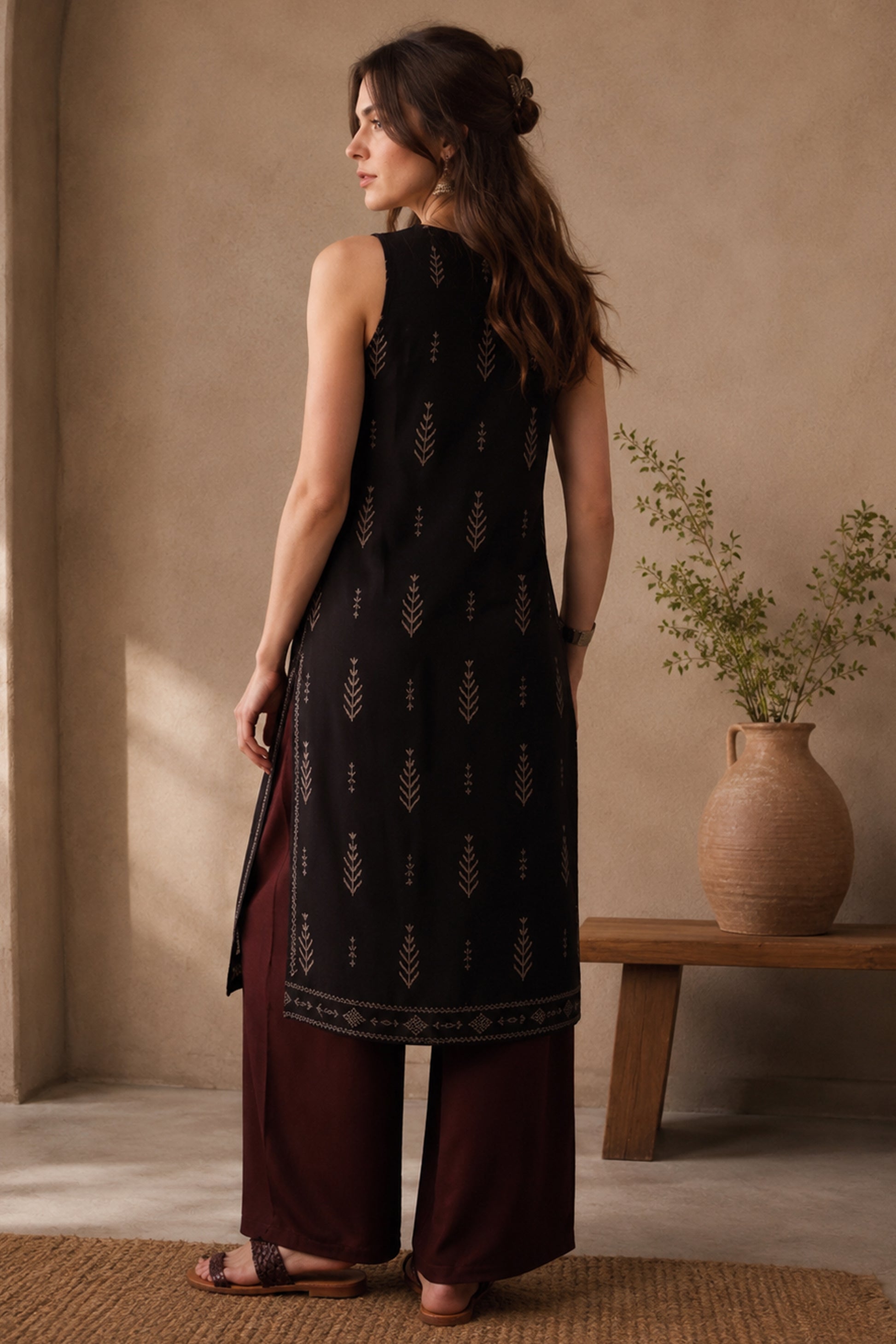 Sleeveless black tunic with wide-leg pants in relaxed styling
