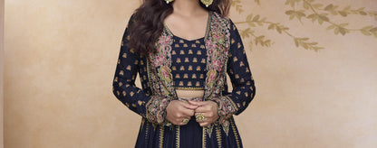 Close-up of black designer Anarkali gown with ornate embroidery, matching crop top, and full-length embellished jacket